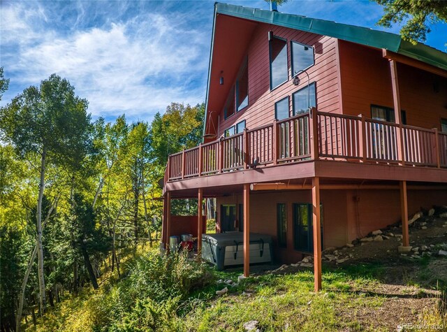 180 Ridge Rd, Cimarron, CO 81220 - rear view of house featuring a hot tub and a deck