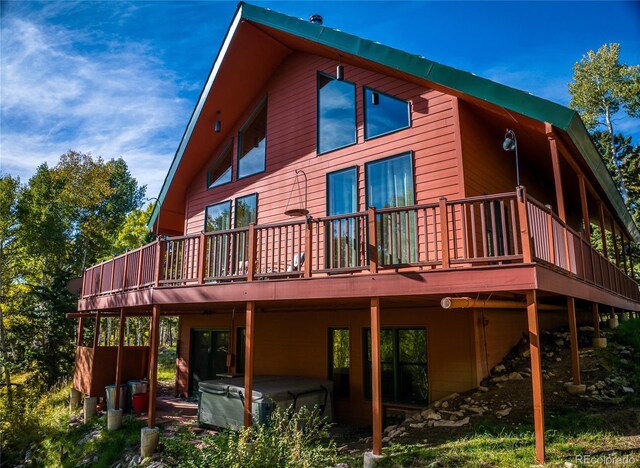 180 Ridge Rd, Cimarron, CO 81220 - back of house with a hot tub and a deck