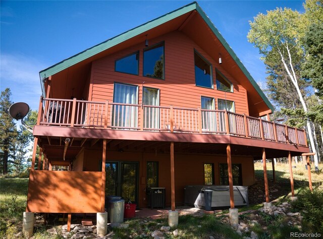 180 Ridge Rd, Cimarron, CO 81220 - back of house featuring a hot tub and a wooden deck