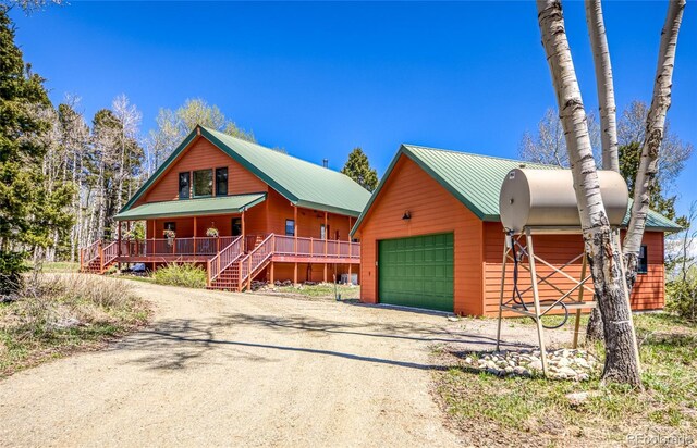 180 Ridge Rd, Cimarron, CO 81220 - chalet / cabin featuring a porch, an outbuilding, metal roof, and driveway
