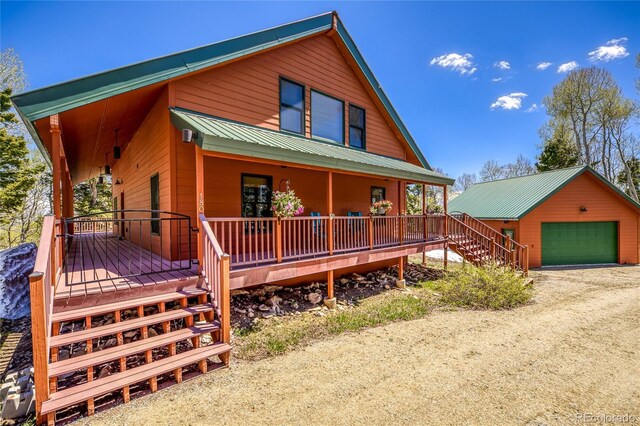 180 Ridge Rd, Cimarron, CO 81220 - chalet / cabin with stairway, a porch, a garage, and metal roof