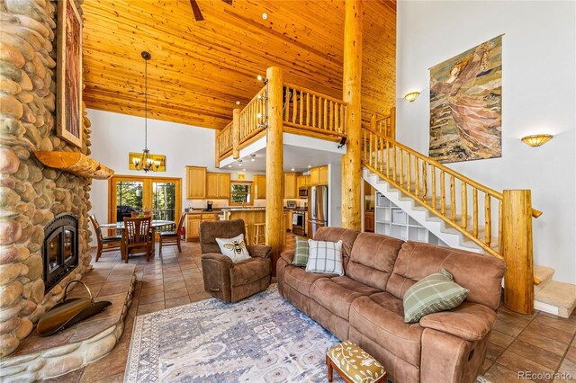 180 Ridge Rd, Cimarron, CO 81220 - living room featuring high vaulted ceiling, stairs, a chandelier, a fireplace, and wooden ceiling
