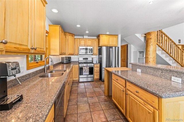180 Ridge Rd, Cimarron, CO 81220 - kitchen with stainless steel appliances, a sink, dark stone counters, recessed lighting, and a center island