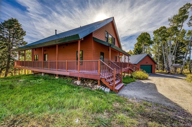 180 Ridge Rd, Cimarron, CO 81220 - view of property exterior with a garage, an outdoor structure, metal roof, driveway, and a deck