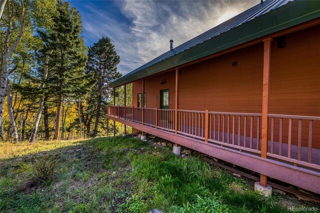 180 Ridge Rd, Cimarron, CO 81220 - view of side of home featuring a wooden deck and metal roof