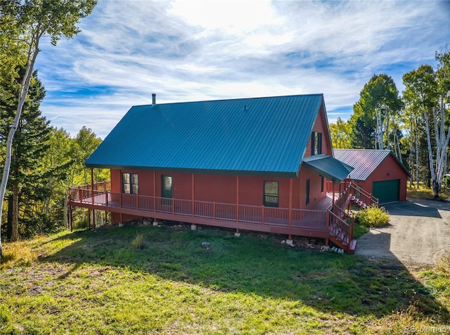 180 Ridge Rd, Cimarron, CO 81220 - rear view of property featuring an outbuilding, a garage, metal roof, a lawn, and a deck