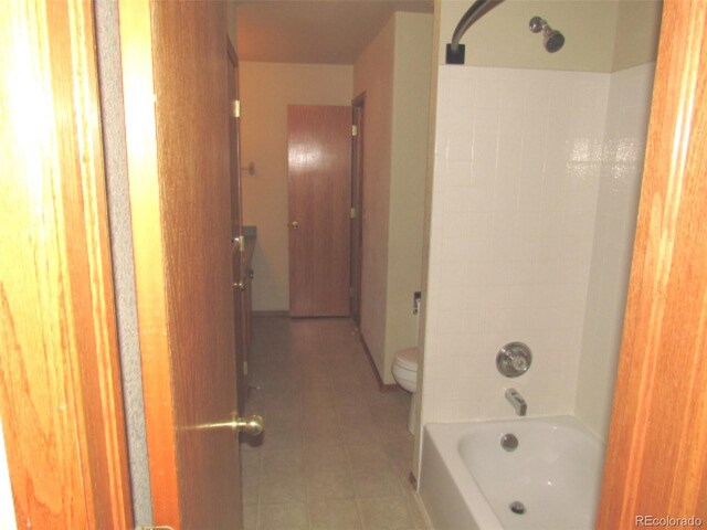 full bathroom featuring tile patterned floors, toilet, and  shower combination
