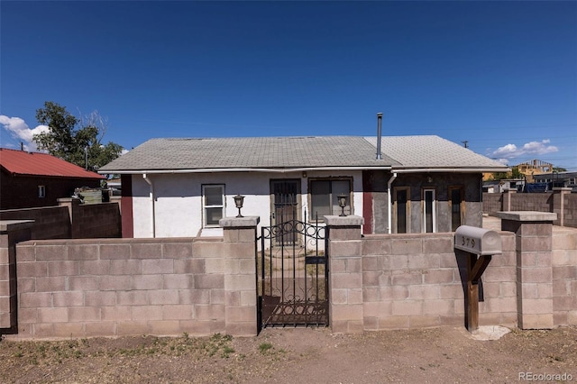379 Sisneros St, Center, CO 81125 - view of front of home with a fenced front yard, a gate, and stucco siding