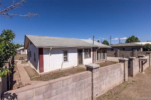 379 Sisneros St, Center, CO 81125 - view of front facade featuring stucco siding and roof with shingles