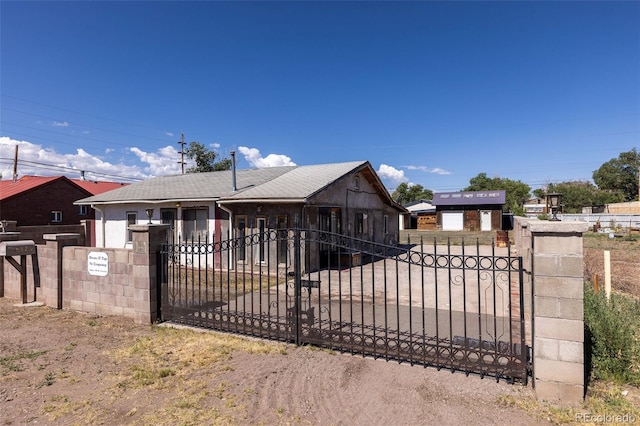 379 Sisneros St, Center, CO 81125 - view of front of house featuring a fenced front yard, a gate, and roof with shingles