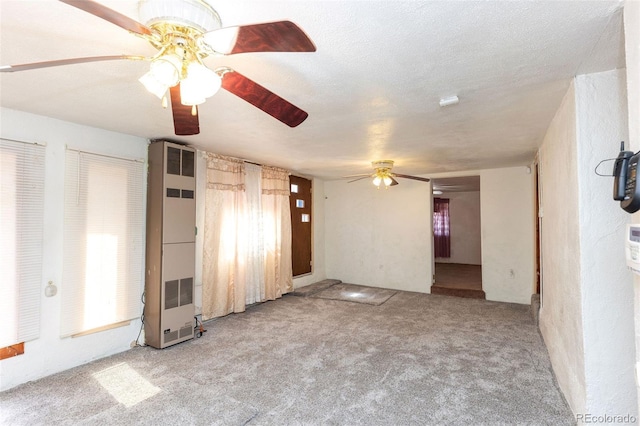 379 Sisneros St, Center, CO 81125 - unfurnished living room with a ceiling fan, a heating unit, and carpet floors