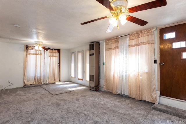 379 Sisneros St, Center, CO 81125 - foyer entrance with carpet floors, plenty of natural light, and ceiling fan