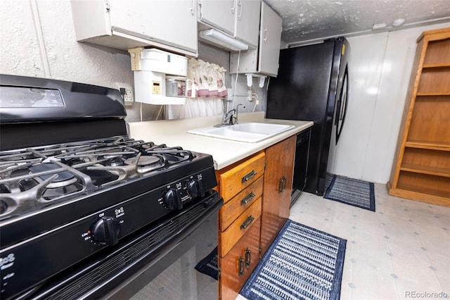 379 Sisneros St, Center, CO 81125 - kitchen with black appliances, light countertops, and light floors