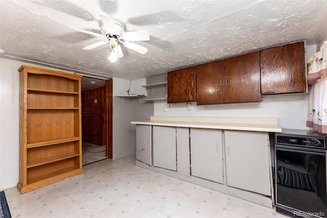 379 Sisneros St, Center, CO 81125 - kitchen with light floors, open shelves, ceiling fan, and a textured ceiling