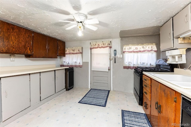 379 Sisneros St, Center, CO 81125 - kitchen featuring black gas range, dishwashing machine, light floors, ceiling fan, and light countertops