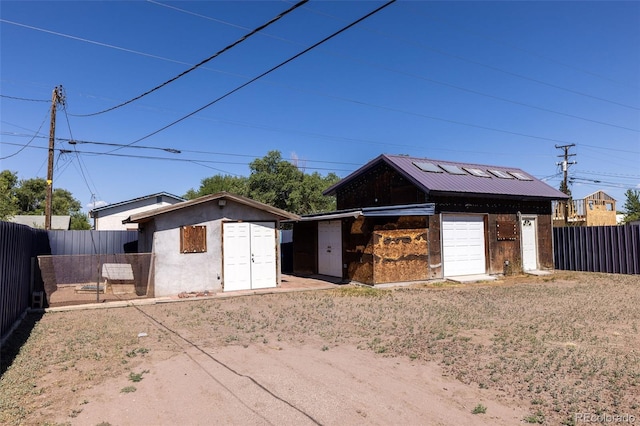 379 Sisneros St, Center, CO 81125 - view of front facade featuring a fenced backyard, a storage unit, and stucco siding