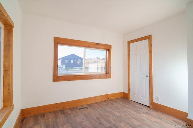 unfurnished room with wood-type flooring