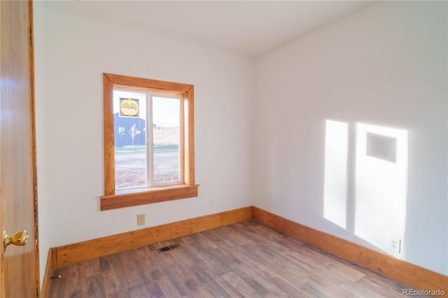 unfurnished room with hardwood / wood-style floors