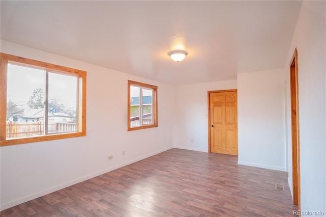 spare room featuring dark hardwood / wood-style floors