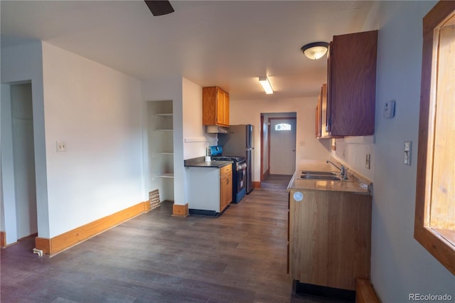 kitchen featuring sink, range with gas stovetop, and dark hardwood / wood-style floors