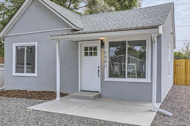 6880 Pontiac St, Commerce City, CO 80022 - entrance to property with a shingled roof and stucco siding