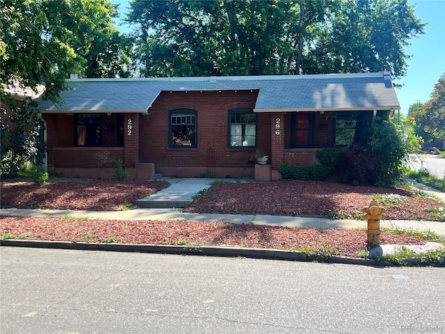 292-296 S Lafayette St, Denver, CO 80209 - view of front of home with brick siding, covered porch, and roof with shingles