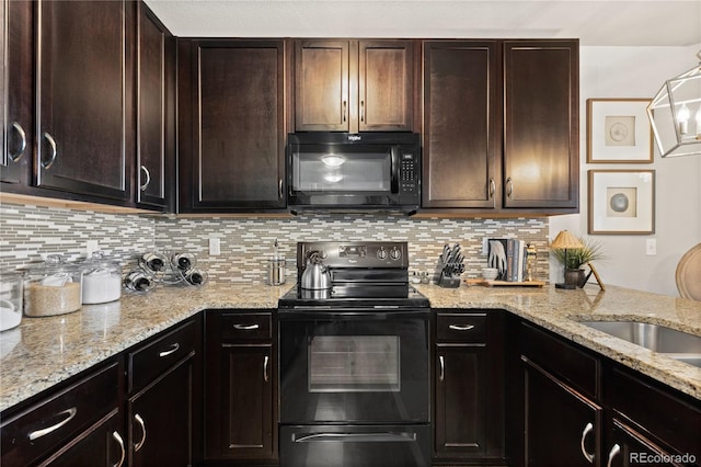 kitchen featuring light stone counters, dark brown cabinetry, backsplash, and black appliances