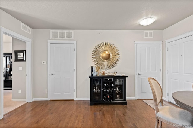 interior space featuring visible vents and wood finished floors