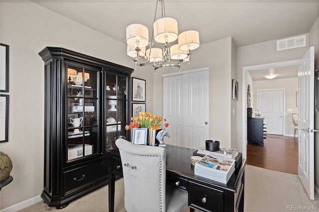 office space featuring a chandelier, visible vents, and baseboards