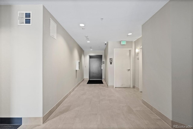 hallway featuring recessed lighting, elevator, baseboards, and visible vents