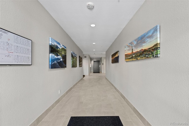 corridor with recessed lighting and baseboards