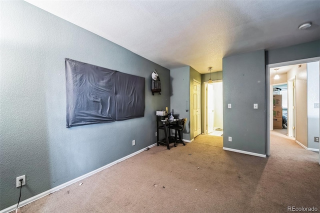 carpeted spare room featuring a textured ceiling