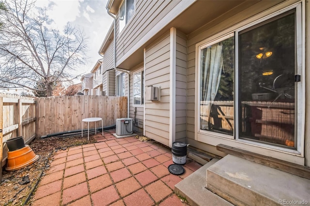 view of patio with cooling unit and central air condition unit