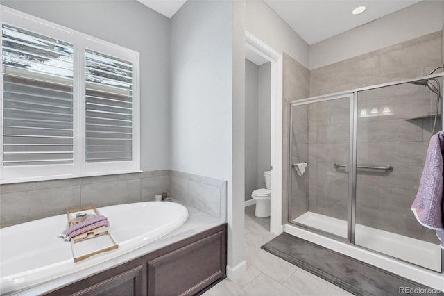 bathroom with tile patterned flooring, shower with separate bathtub, and toilet