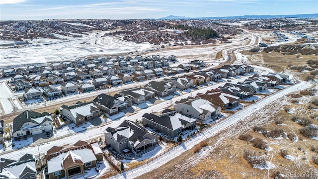 snowy aerial view featuring a mountain view