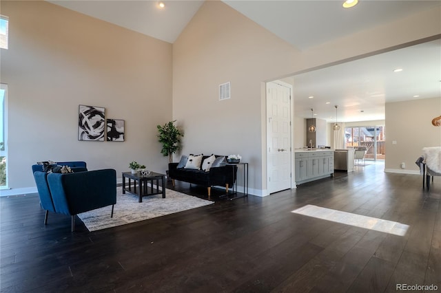 living room with visible vents, high vaulted ceiling, dark wood finished floors, recessed lighting, and baseboards