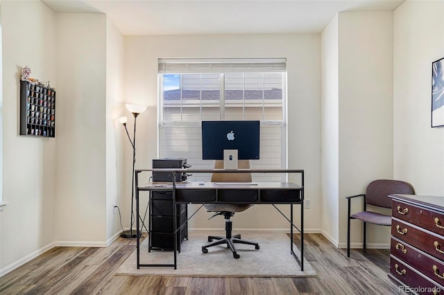 office area with baseboards and wood finished floors