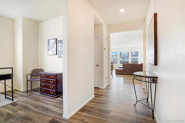 hall featuring recessed lighting, wood finished floors, and baseboards