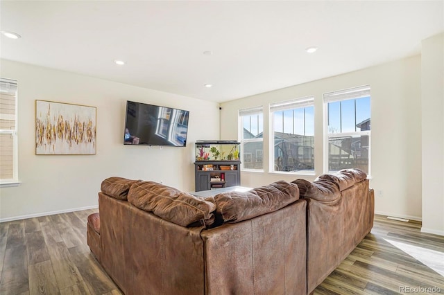 living area with recessed lighting, baseboards, and wood finished floors