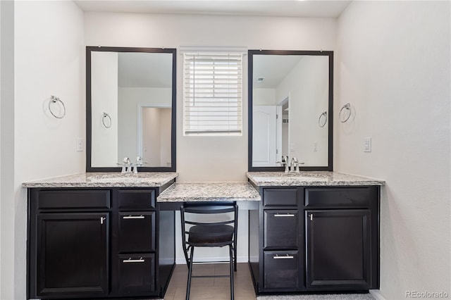 full bathroom with two vanities and a sink