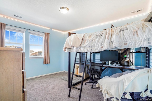 carpeted bedroom with baseboards, visible vents, and a textured ceiling