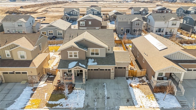 snowy aerial view with a residential view