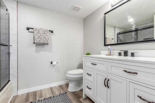 4899 S Dudley St Unit 14F, Littleton, CO 80123 - bathroom with vanity, wood finished floors, and combined bath / shower with glass door