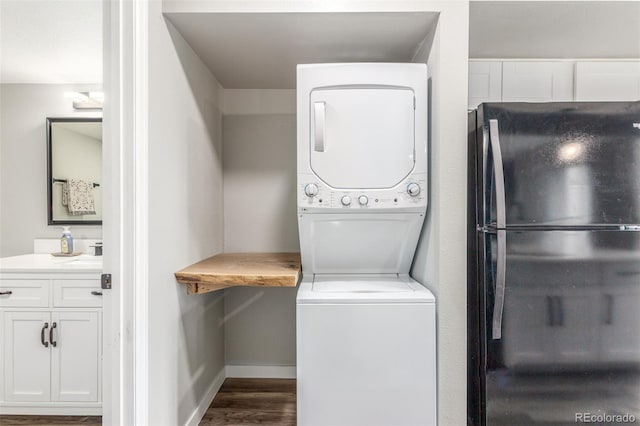 4899 S Dudley St Unit 14F, Littleton, CO 80123 - laundry room with estacked washer and dryer and dark wood-style floors