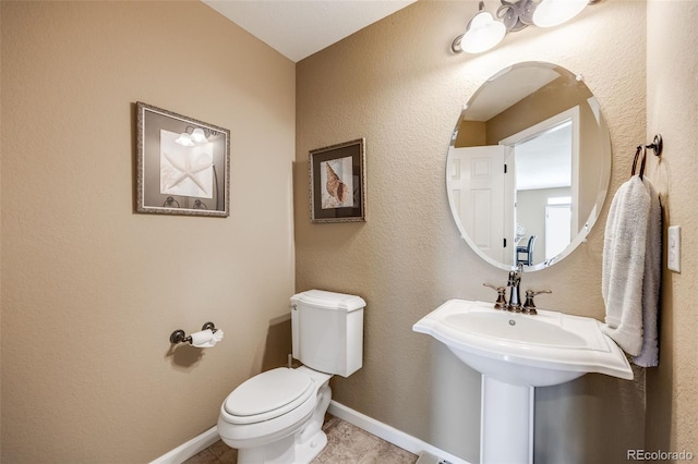 26764 E Canyon Ave, Aurora, CO 80016 - half bathroom with toilet, tile patterned floors, and baseboards