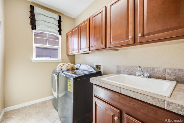 26764 E Canyon Ave, Aurora, CO 80016 - laundry room with cabinet space, washing machine and clothes dryer, baseboards, and light tile patterned floors