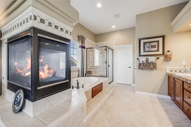 26764 E Canyon Ave, Aurora, CO 80016 - bathroom featuring a shower stall, a garden tub, vanity, tile patterned floors, and baseboards