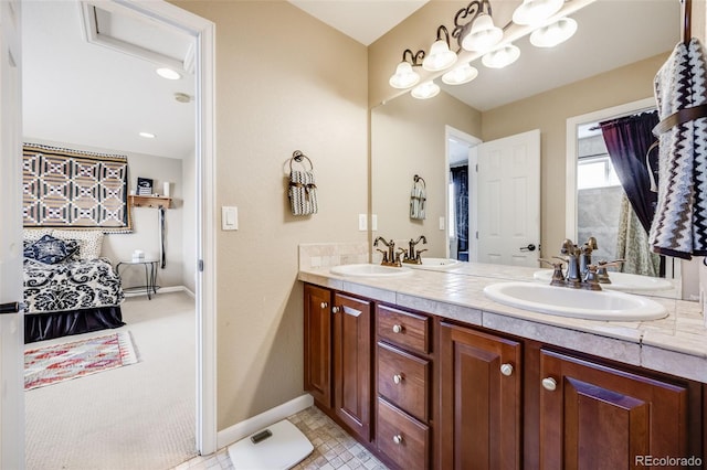 26764 E Canyon Ave, Aurora, CO 80016 - ensuite bathroom featuring double vanity and baseboards