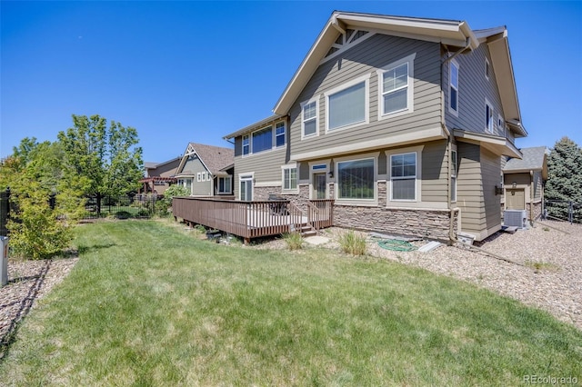 26764 E Canyon Ave, Aurora, CO 80016 - rear view of house with a wooden deck, stone siding, and central AC unit