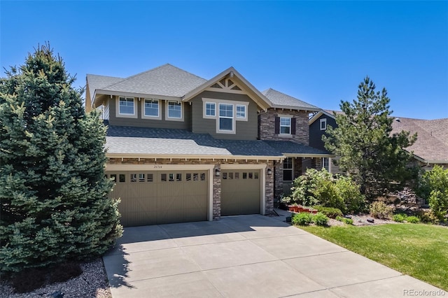 26764 E Canyon Ave, Aurora, CO 80016 - craftsman inspired home featuring stone siding, an attached garage, driveway, and roof with shingles